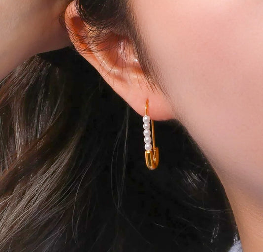 Gold plated pearl clip earrings on a model