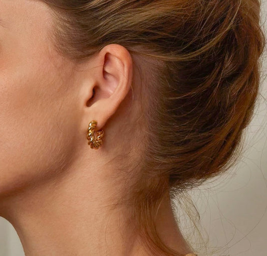 Small gold plated twisted hoop on a model